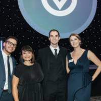 Guests posing in front of the stage at Enrichment.